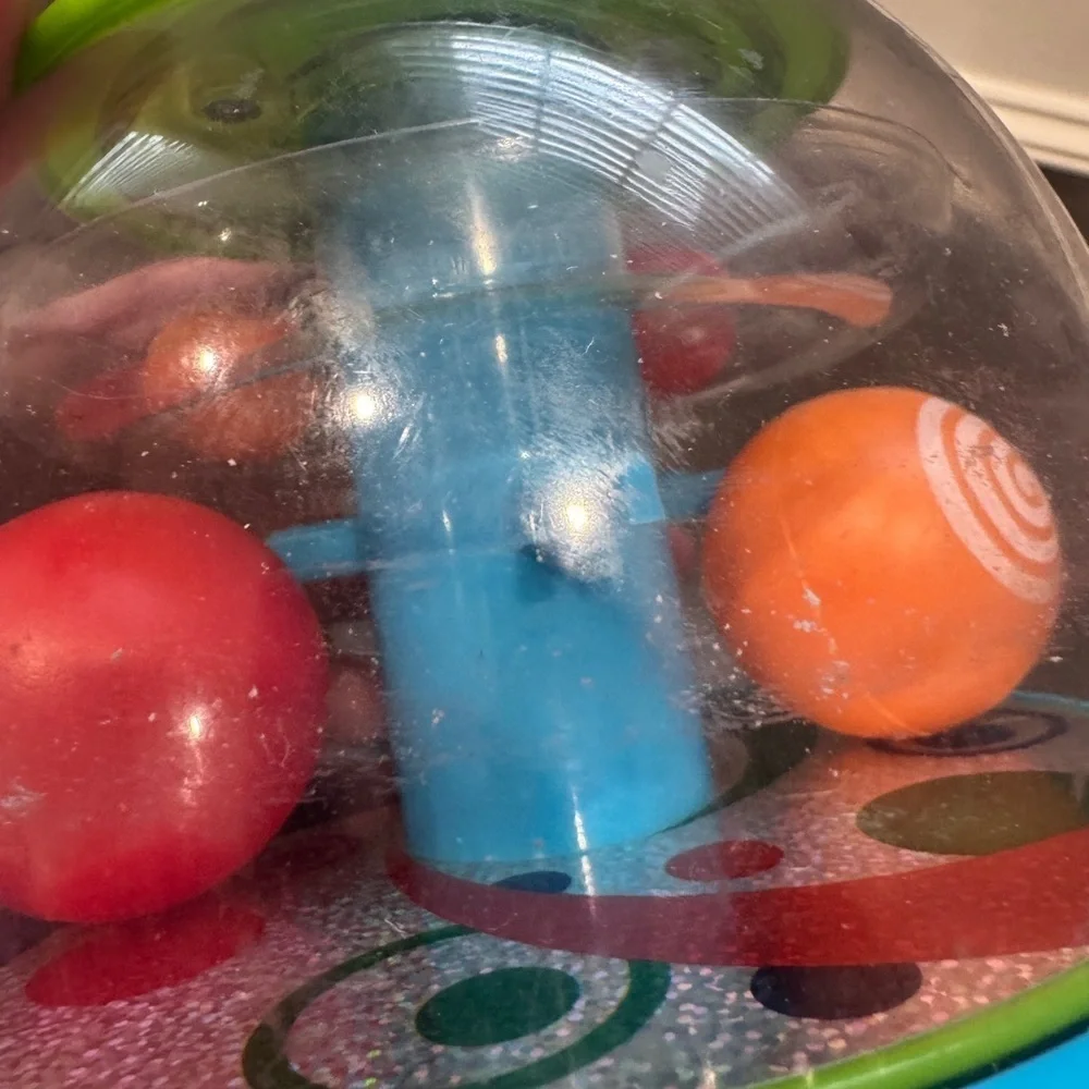 Orange and Green Press and Spin Learning Baby Toy